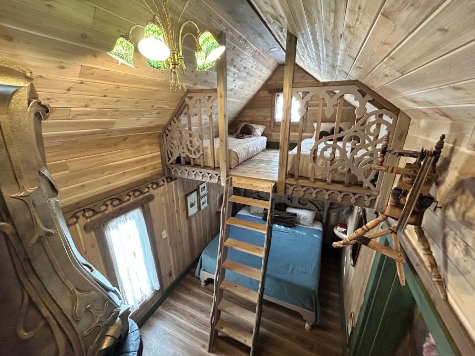 interior of rumpelstilskin's tower  with two floors and wood ceilings