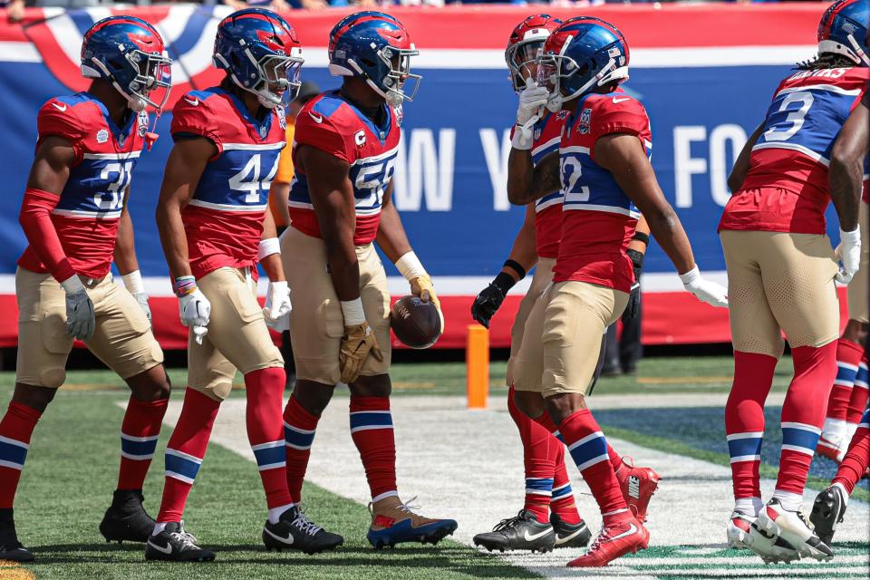 Sep 8, 2024; East Rutherford, New Jersey, USA; New York Giants linebacker Boogie Basham (55) celebrates his fumble recovery with teammates during the first quarter against the Minnesota Vikings at MetLife Stadium. Mandatory Credit: Vincent Carchietta-Imagn Images