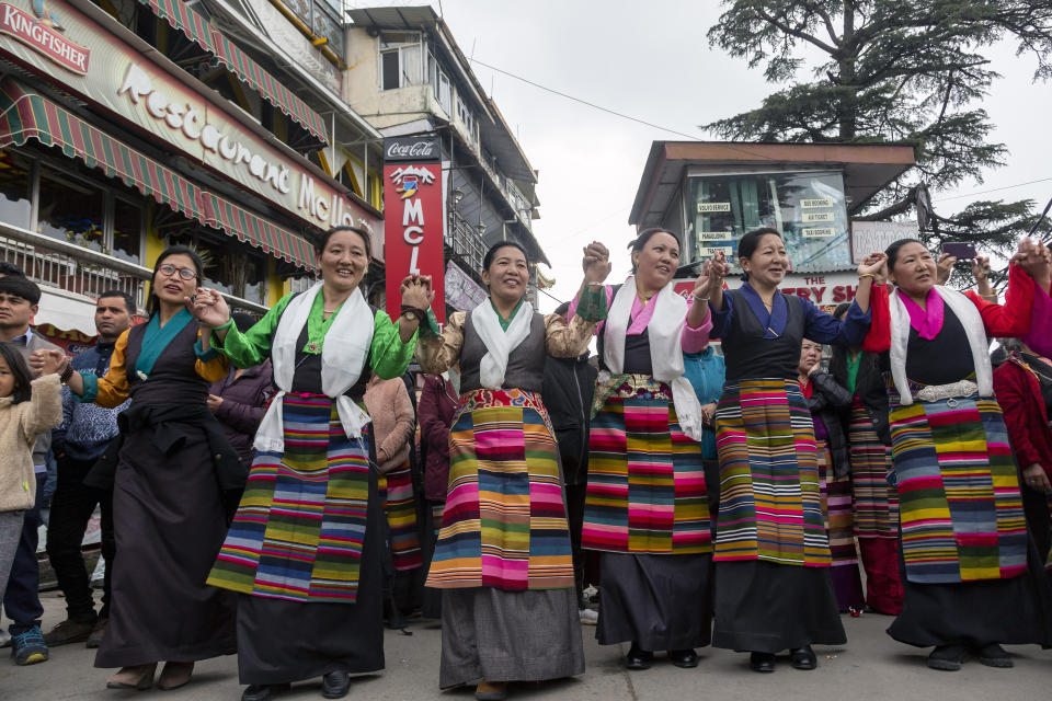 Exile Tibetans perform a traditional communal dance in the town square to celebrate the third day of the Tibetan New Year or Losar in Dharmsala, India, Wednesday, Feb. 26, 2020. (AP Photo/Ashwini Bhatia)