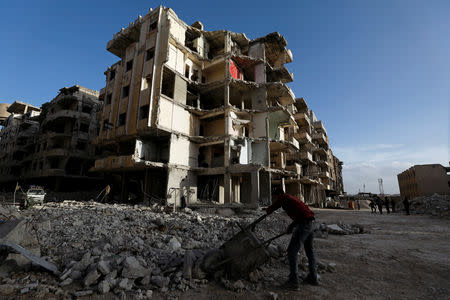 Workers work at a construction site in Ein Terma, a district of eastern Ghouta, Syria February 26, 2019. REUTERS/Omar Sanadiki