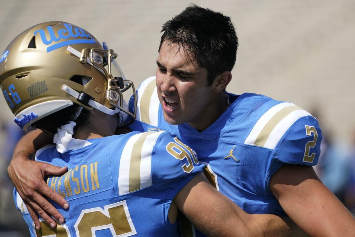 UCLA's Nicholas Barr-Mira, right, celebrates with teammate Ari Libenson after Barr-Mira's game-winning kick Sept. 17, 2022.