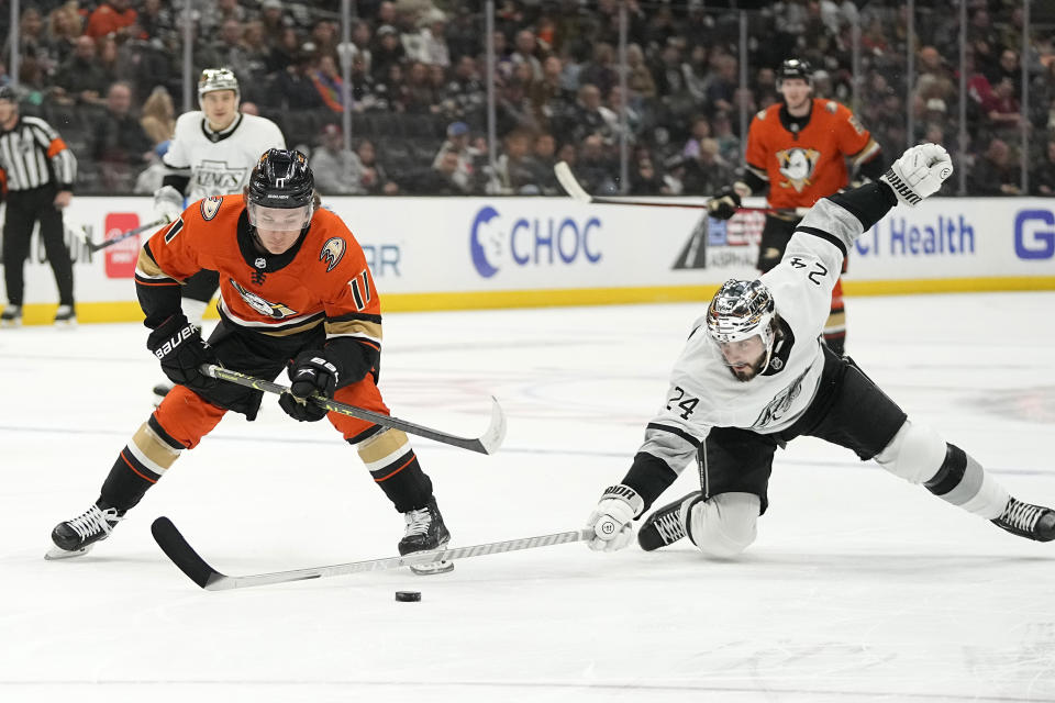 Los Angeles Kings center Phillip Danault, right, reaches in on Anaheim Ducks center Trevor Zegras during the first period of an NHL hockey game Friday, Feb. 17, 2023, in Anaheim, Calif. (AP Photo/Mark J. Terrill)