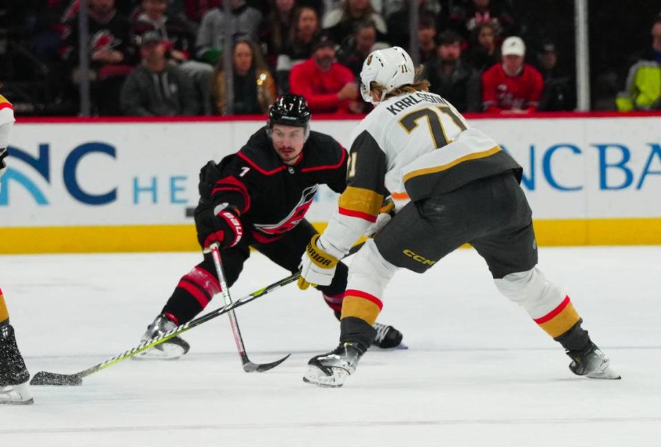 Dec 19, 2023; Raleigh, North Carolina, USA; Carolina Hurricanes defenseman Dmitry Orlov (7) defends against Vegas Golden Knights center William Karlsson (71) during the first period at PNC Arena. Mandatory Credit: James Guillory-USA TODAY Sports James Guillory/James Guillory-USA TODAY Sports