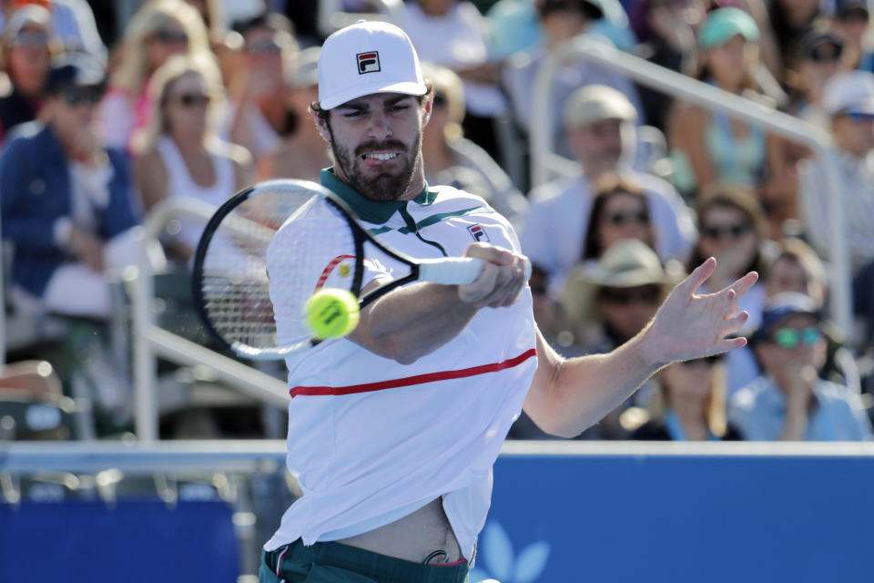 Reilly Opelka returns to Yoshihito Nishioka, of Japan, during the Delray Beach Open singles final tennis match in Delray Beach, Fla., Sunday, Feb. 23, 2020. (AP Photo/Lynne Sladky)