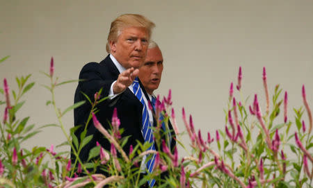 U.S. President Donald Trump talks with Vice President Mike Pence as they walk along the Colonnade at the White House in Washington September 6, 2017. REUTERS/Kevin Lamarque