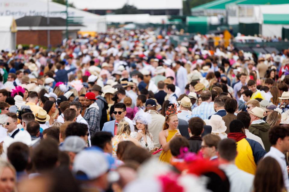 Derby attendees crowd the infield at Churchill Downs.