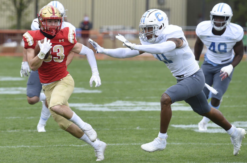 VMI wide receiver Chance Knox (left) is run down by The Citadel's Parrish Gordon during the first half of an NCAA college football game Saturday, April 17, 2021, in Lexington, Va. (David Hungate/Roanoke Times via AP)