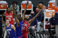 New Orleans Pelicans forward Brandon Ingram (14) shoots next to Los Angeles Clippers center Serge Ibaka (9) during the first quarter of an NBA basketball game Wednesday, Jan. 13, 2021, in Los Angeles. (AP Photo/Ashley Landis)