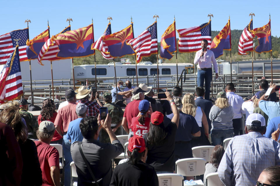 Donald Trump Jr. speaks at an Oct. 15, 2020, rally for his father, President Donald Trump, at the rodeo grounds in Williams, Arizona. Navajo Nation President Myron Lizer makes no qualms about it: As one of the top officials on the country's largest Native American reservation, he's a proud Donald Trump supporter. The Navajo Nation vice president says Native American values - hard work, family and ranching - align more with the GOP than with Democrats. (AP Photo/Felicia Fonseca)