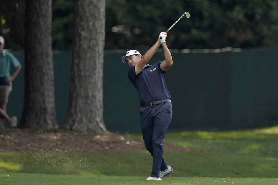 Patrick Cantlay hits from the fairway on the 14th hole during the final round of play in the Tour Championship golf tournament at East Lake Golf Club, Sunday, Sept. 5, 2021, in Atlanta. Cantlay won the event and the FedEx Cup. (AP Photo/Brynn Anderson)