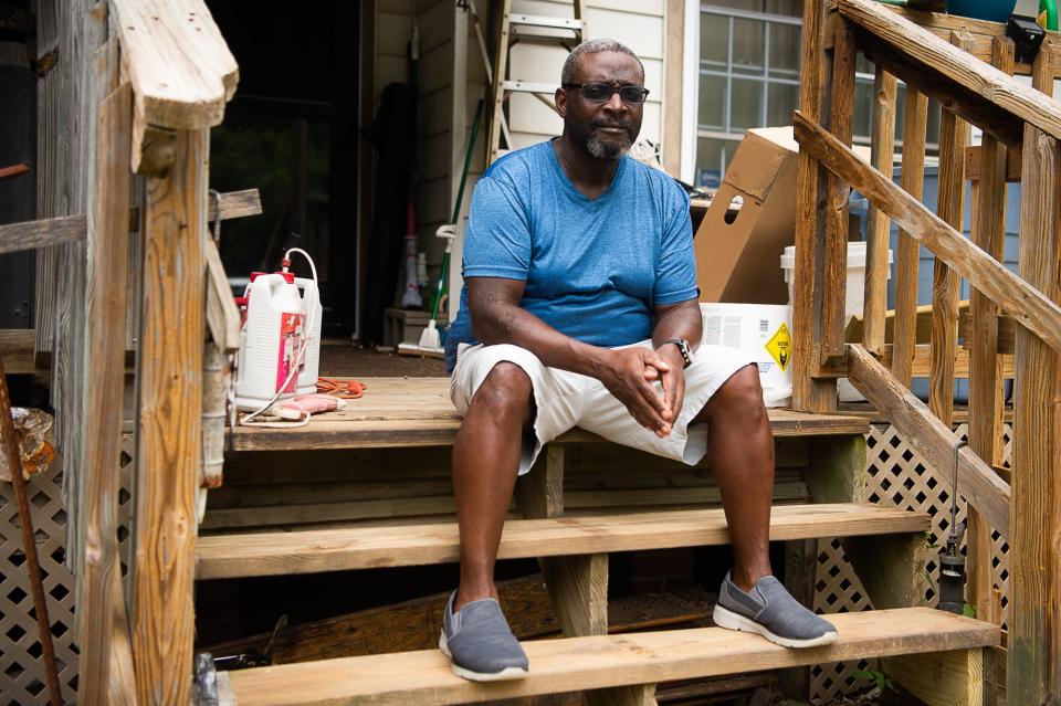 Asheville resident Raymond Harrell poses for a photo on his front step on Wednesday, July 7, 2021.