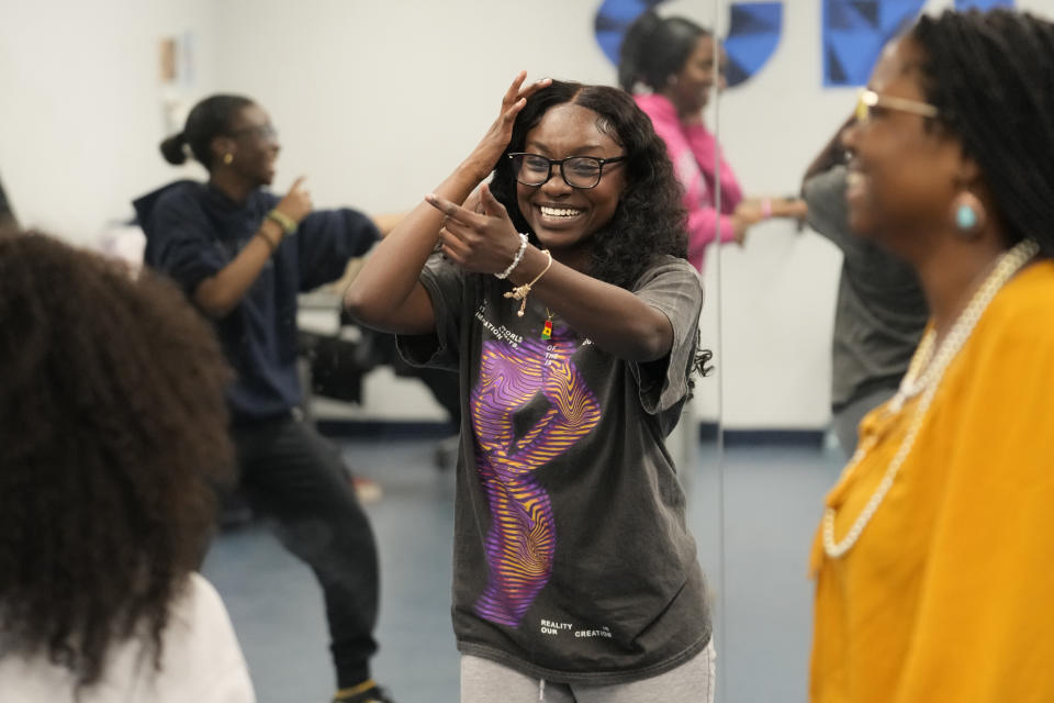 Hillary Amofa, laughs as she participates in a team building game with members of the Lincoln Park High School step team after school Friday, March 8, 2024, in Chicago. When she started writing her college essay, Amofa told the story she thought admissions offices wanted to hear. She wrote about being the daughter of immigrants from Ghana, about growing up in a small apartment in Chicago. She described hardship and struggle. Then she deleted it all. "I would just find myself kind of trauma-dumping," said the 18 year-old senior, "And I'm just like, this doesn't really say anything about me as a person." (AP Photo/Charles Rex Arbogast)