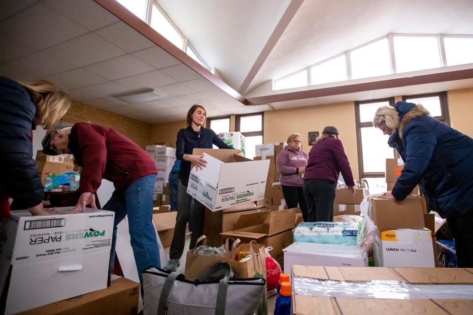 Olga Hietpas, center, fills boxes with supplies alongside other volunteers with Wisconsin Ukrainians Inc. on March 22 at St. Matthew Orthodox Church in Green Bay. Samantha Madar/USA TODAY NETWORK-Wisconsin