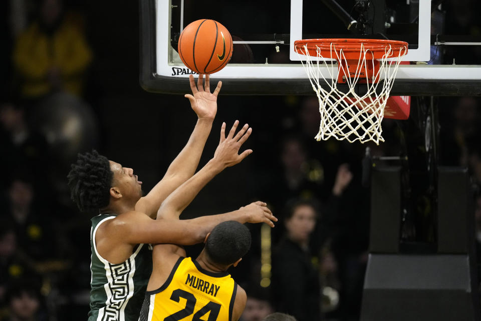 Michigan State guard A.J. Hoggard, left, is fouled by Iowa forward Kris Murray while driving to the basket during the second half of an NCAA college basketball game, Saturday, Feb. 25, 2023, in Iowa City, Iowa. (AP Photo/Charlie Neibergall)