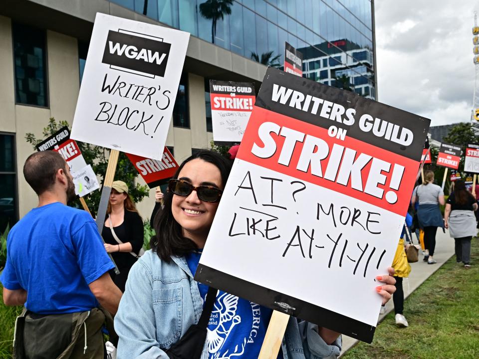 Writer Ilana Pena holds her sign on the picket line on the fourth day of the strike by the Writers Guild of America in front of Netflix in Hollywood, California, on May 5, 2023. - The Hollywood writers' strike broke out this week over pay, but the refusal of studios like Netflix and Disney to rule out artificial intelligence replacing human scribes in the future has only fueled anger and fear on the picket lines.