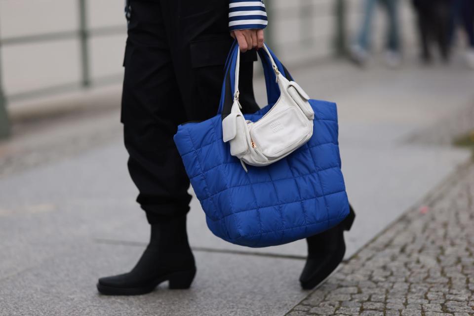 A person carries tote bags in Berlin, Germany.