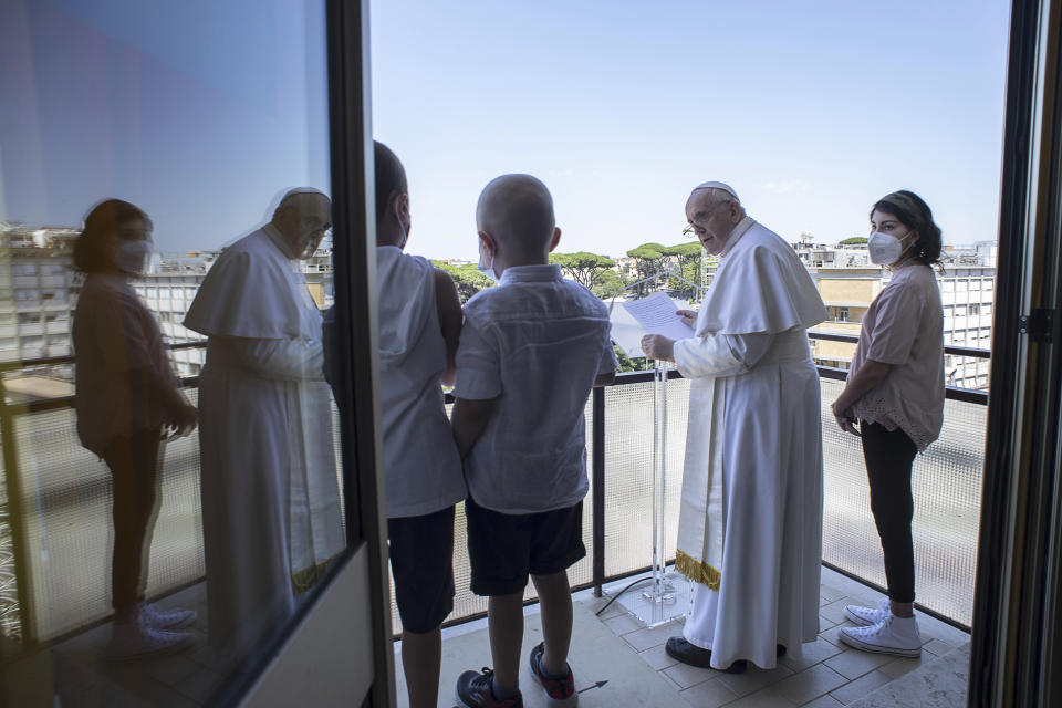 Pope Francis appears with some young oncologic patients at a balcony of the Agostino Gemelli Polyclinic in Rome, Sunday, July 11, 2021, where he was hospitalized for intestine surgery, to deliver his traditional Sunday blessing. (Vatican Media via AP)