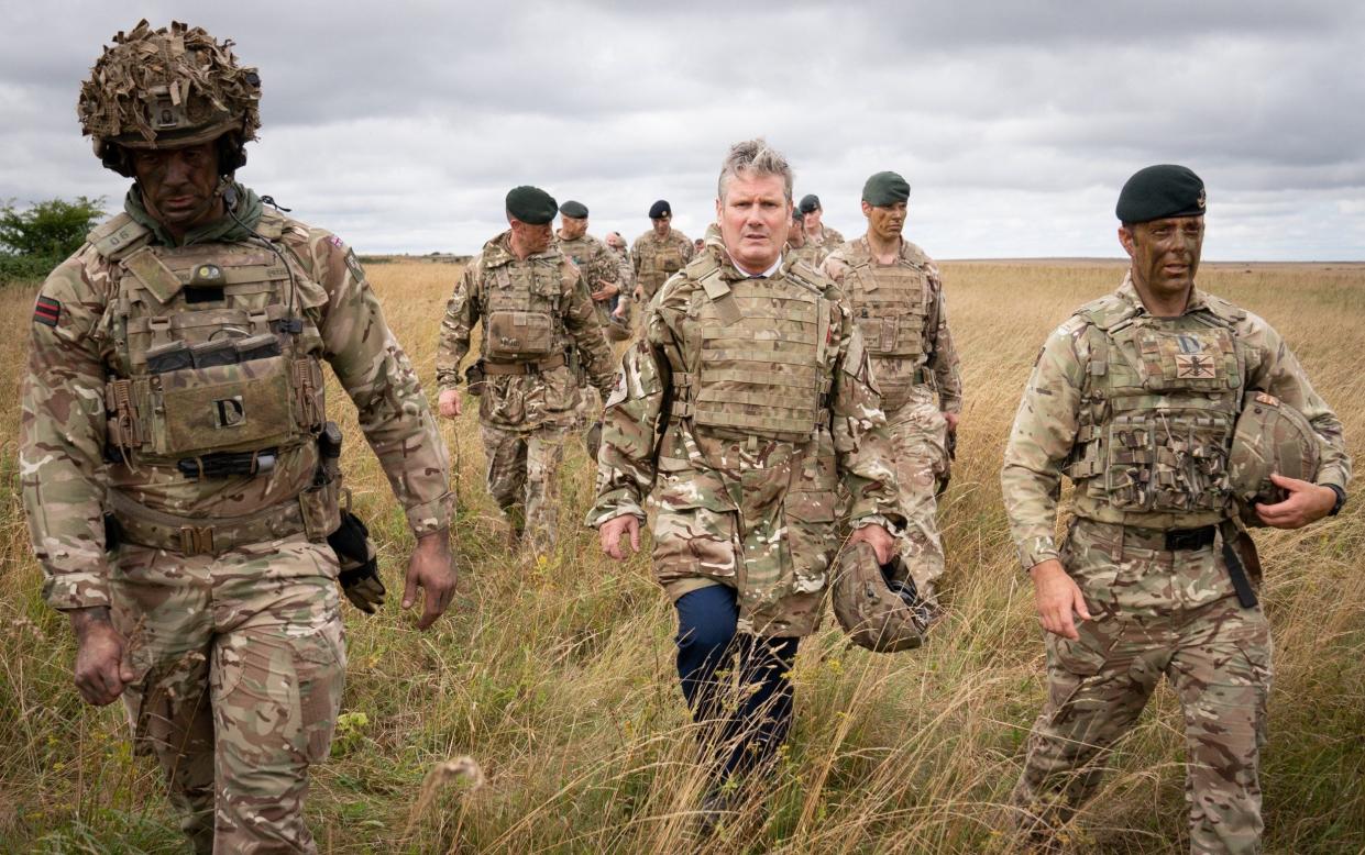Labour leader Sir Keir Starmer (C) pictured meeting British soldiers in Wiltshire in 2022