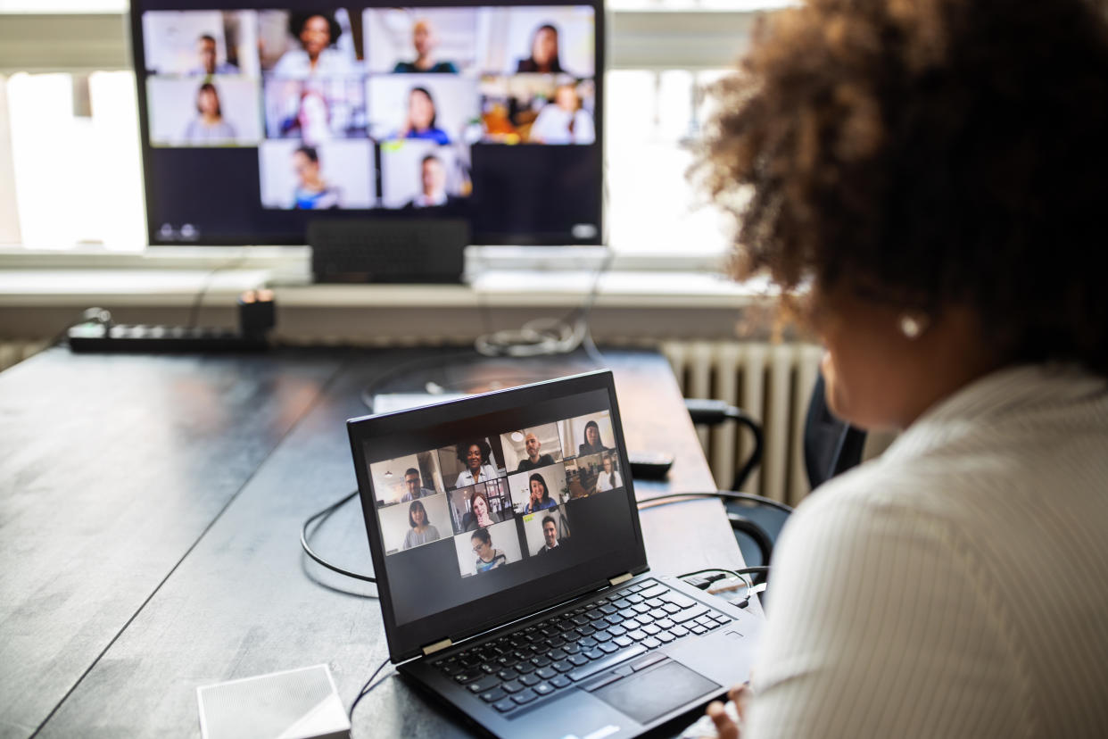 Businessman sitting in conference room and having a video call meeting. Woman on a video conference meeting at office.