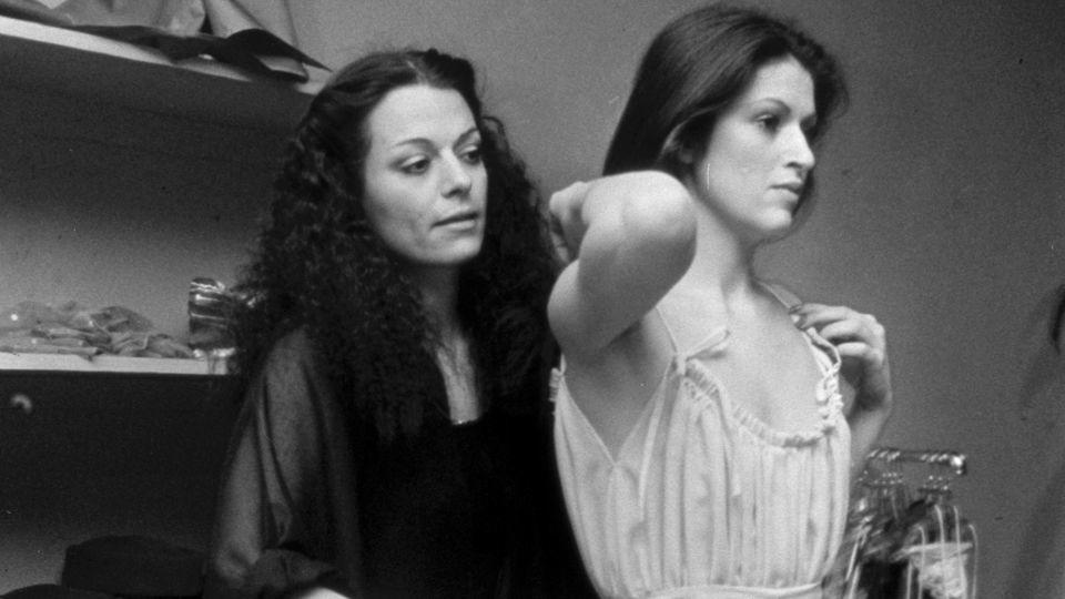 Norma Kamali styling a model at her New York boutique in 1977. The brand's archive forms a key part of their plans to embrace AI. - Lynn Karlin/Penske Media/Getty Images