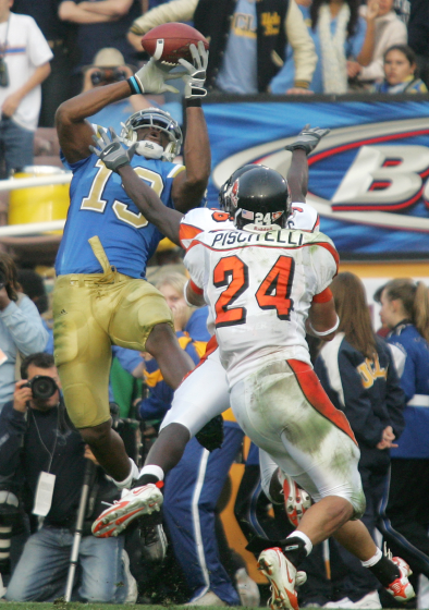 UCLA wide receiver Mercedes Lewis, left, catches a touchdown pass from Drew Olson.