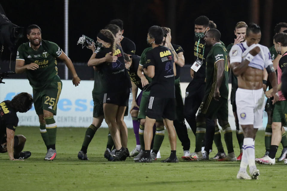 Portland Timbers players celebrate after defeating Orlando City 2-1, during an MLS soccer tournament, Tuesday, Aug. 11, 2020, in Kissimmee, Fla. (AP Photo/John Raoux)