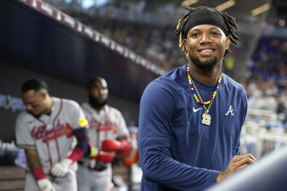 Atlanta Braves' Ronald Acuna Jr. smiles in the dugout during a baseball game against the Miami Marlins, Sunday, Sept. 17, 2023, in Miami. (AP Photo/Lynne Sladky)