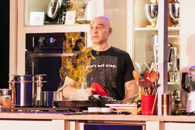 <p>Huge Galdones</p> Michael Symon burns a hole in the mirror above the stage at the Classic Cook-Off