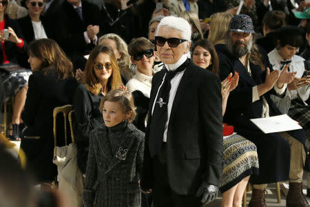 German designer Karl Lagerfeld and model Hudson Kroenig appear at the end of his Fall/Winter 2016/2017 women's ready-to-wear collection for fashion house Chanel at the Grand Palais in Paris, France, March 8, 2016. REUTERS/Gonzalo Fuentes