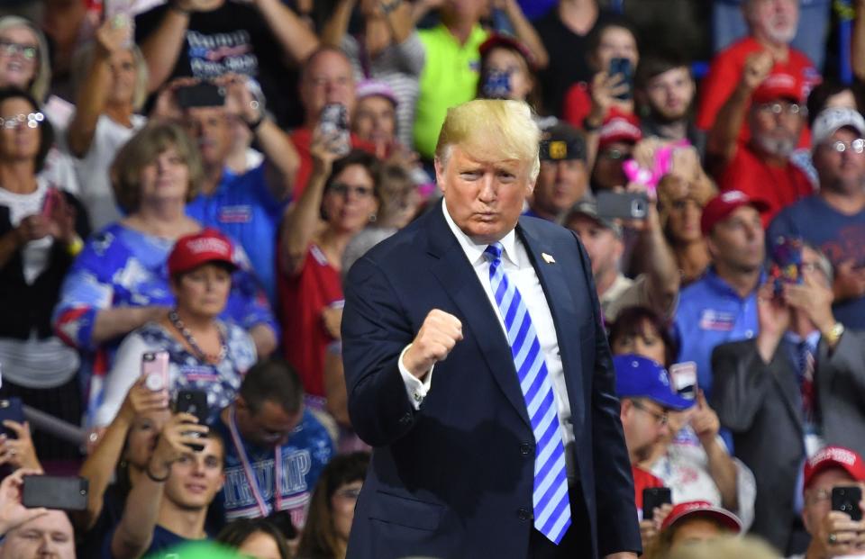 Former President Donald Trump is backing Rep. Alex Mooney in a U.S. House Republican primary against Rep. David McKinley. Trump endorsed Mooney after he voted against the infrastructure bill. This file photo from August 21, 2018, shows Trump saluting his supporters after speaking at a political rally at the Charleston Civic Center in Charleston, West Virginia.