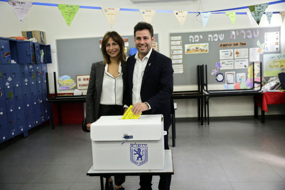 Mayoral candidate Ofer Berkovitch, right, and his wife Dina pose for the media as they cast their votes at a polling station in Jerusalem, Tuesday, Nov. 13, 2018. Israelis were choosing their next mayors in dozens of locations across the country Tuesday, with the main focus on the largest city of Jerusalem. (AP Photo/Mahmoud Illean)