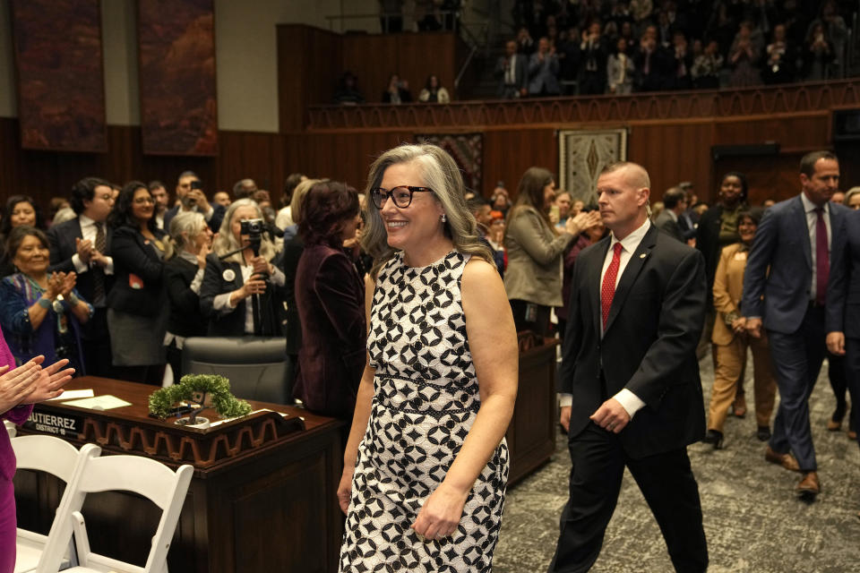 Arizona Democratic Gov. Katie Hobbs smiles as she arrives on the House of Representatives floor to deliver the State of the State address at the Arizona state capitol Monday, Jan. 8, 2024, in Phoenix. (AP Photo/Ross D. Franklin)