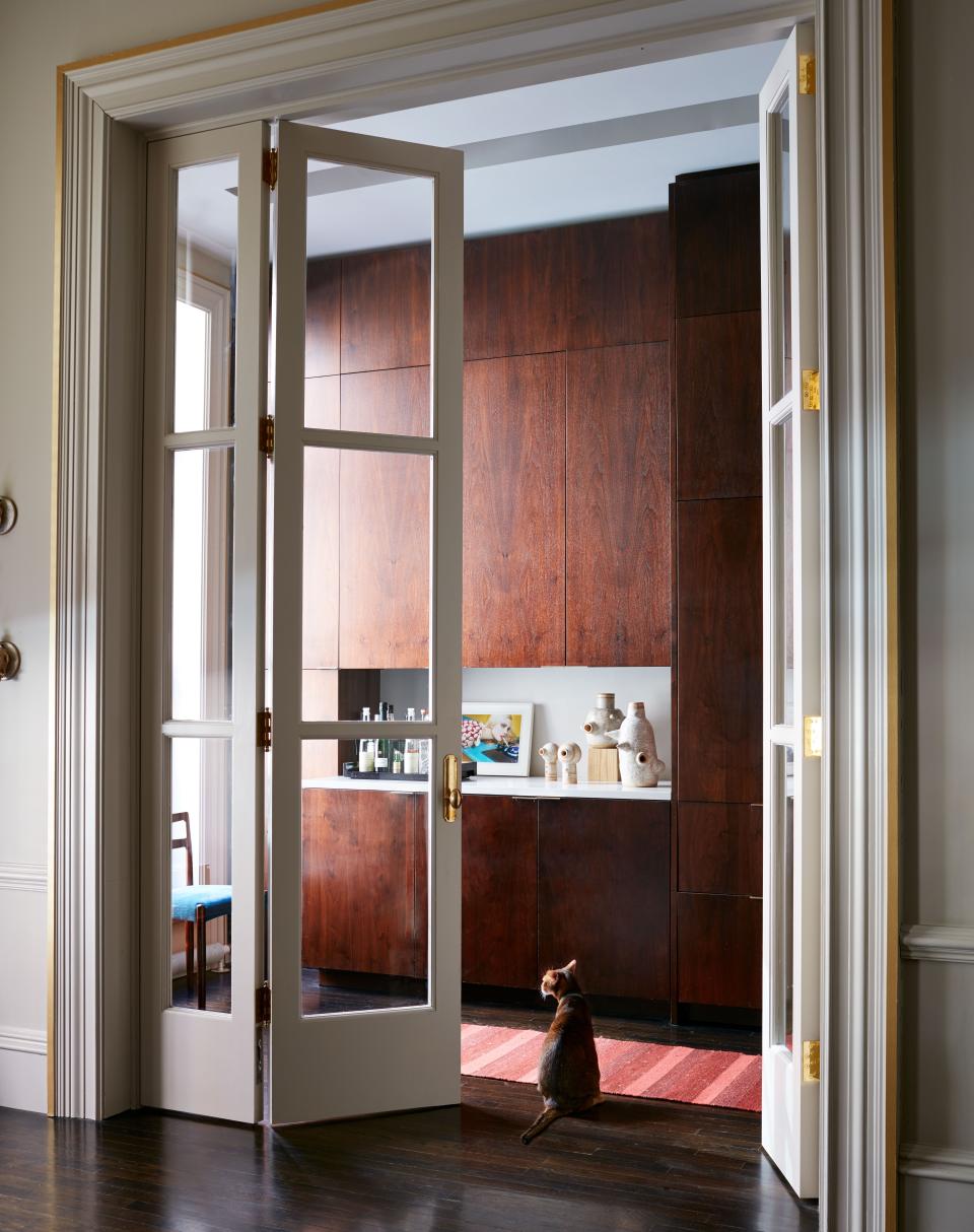 A view through French doors of the apartment's kitchen, whose cabinets are custom designed in walnut. Otero's contractor was from Simply Elegant.