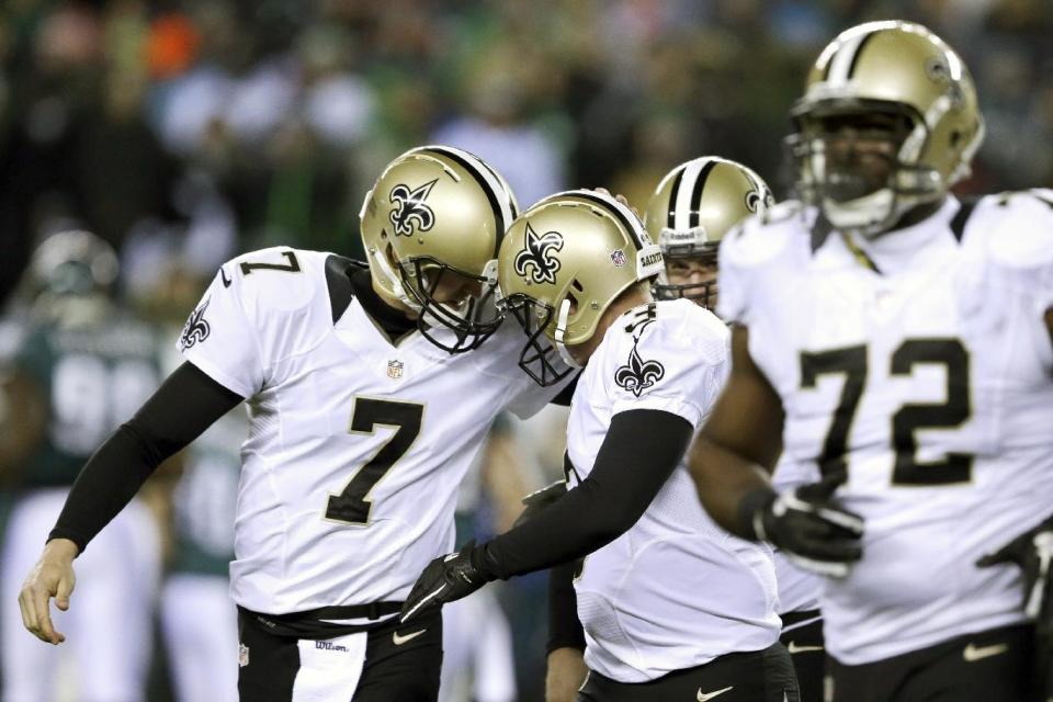 New Orleans Saints' Luke McCown (7) celebrates with Shayne Graham (3) after Graham's field goal during the first half of an NFL wild-card playoff football game against Philadelphia Eagles, Saturday, Jan. 4, 2014, in Philadelphia. (AP Photo/Julio Cortez)