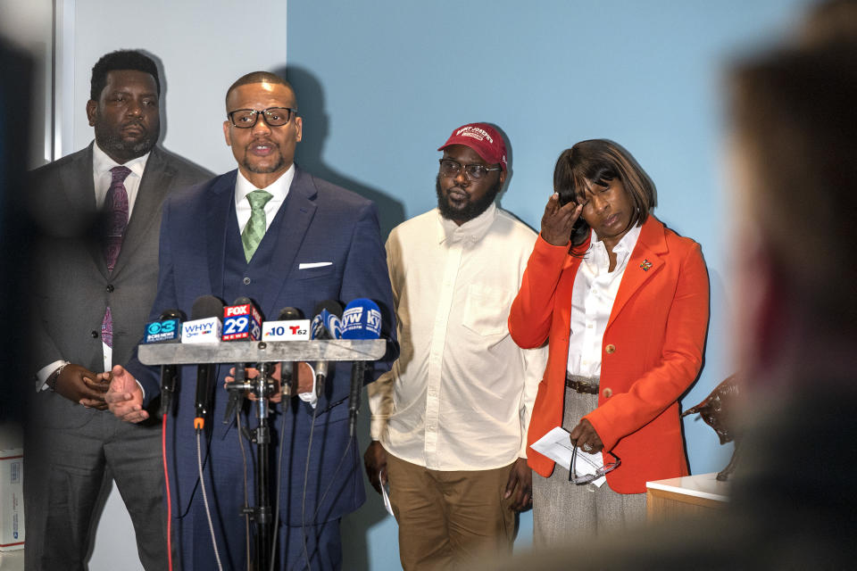 Celena Morrison-McLean, right, and Darius McLean stand behind their attorneys Kevin Mincey, left, and Riley Ross, second from left, during a news conference on Thursday, March 7, 2024 in Philadelphia. Celena Morrison-McLean, a Philadelphia city official was arrested over the weekend during a traffic stop and started recording the incident because she feared for her husband's life as a trooper handcuffed him on a rainy elevated highway. (Tom Gralish/The Philadelphia Inquirer via AP)