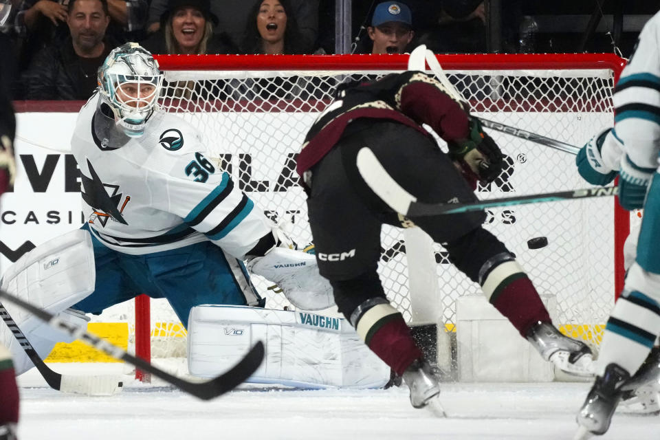 Arizona Coyotes left wing Matias Maccelli, right, scores a goal against San Jose Sharks goaltender Kaapo Kahkonen (36) during the second period of an NHL hockey game Friday, Dec. 15, 2023, in Tempe, Ariz. (AP Photo/Ross D. Franklin)