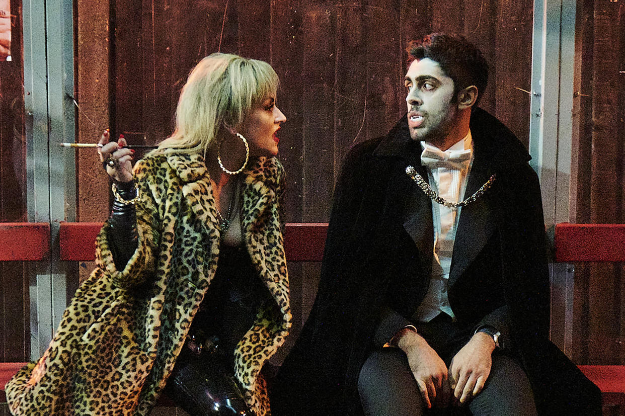  Count Abdulla stars Arian Nik and Jaime Winstone sitting on a bench in vampire costumes. . 