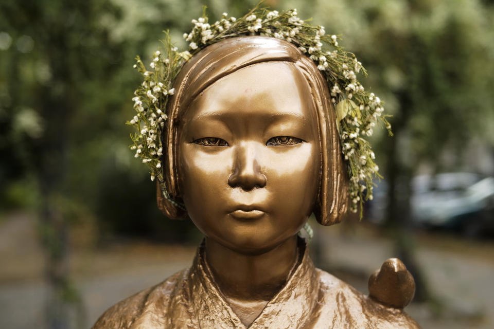 A statue commemorating so-called 'comfort women', an euphemism given by Japan to the women and girls enslaved for sex by the Japanese army during World War II, is displayed at a residential area in central Berlin, Germany, Friday, Oct. 9, 2020. (AP Photo/Markus Schreiber)