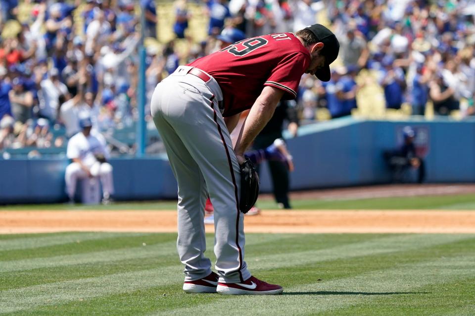 Arizona Diamondbacks starter Tyler Gilbert looks down after giving up a two-run home run to Los Angeles Dodgers' Justin Turner during the sixth inning of the first game of a baseball double-header Tuesday, May 17, 2022, in Los Angeles. (AP Photo/Marcio Jose Sanchez)