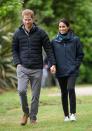 <p>Harry holds hands with Meghan as they walk around Abel Tasman National Park Wellington, New Zealand. </p>