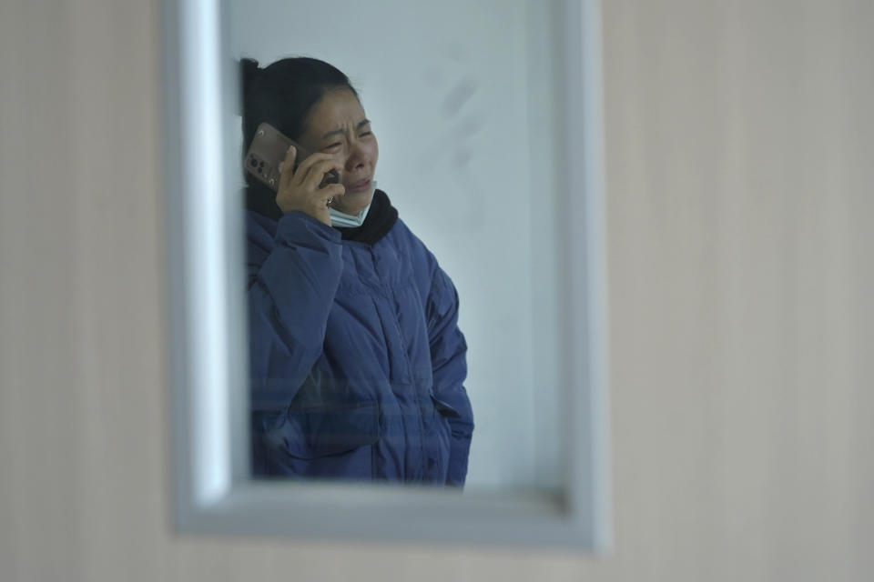 In this photo released by Xinhua News Agency, a relative of injured people reacts as she talks to a phone at a hospital following a traffic accident in Nanchang County in east China's Jiangxi Province, Sunday, Jan. 8, 2023. A traffic accident in southern China killed more than a dozen people and injured more people early Sunday as the annual Lunar New Year holiday travel rush got underway, authorities said. (Wan Xiang/Xinhua via AP)