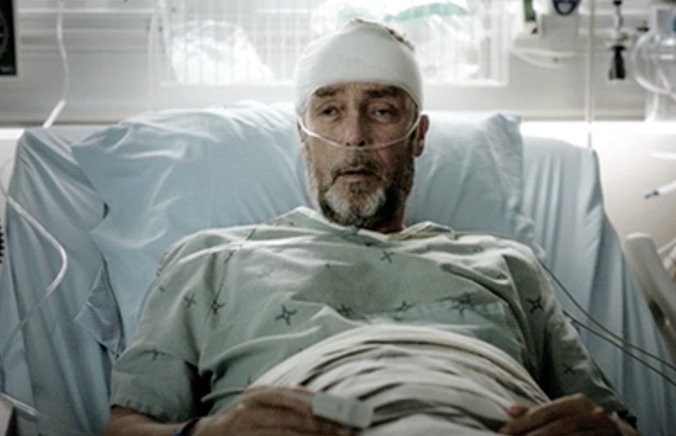 a man with his head wrapped in the hospital