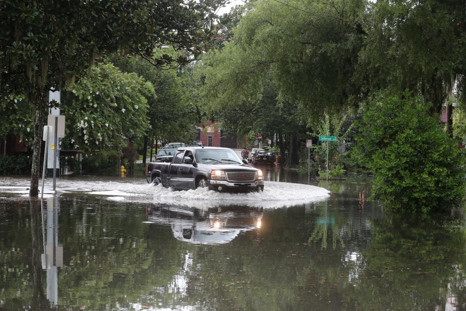 A lifted pick-up drives through a flooded intersection at Jefferson and 38th Streets following an afternoon thunderstorm on Monday, July 17, 2023.