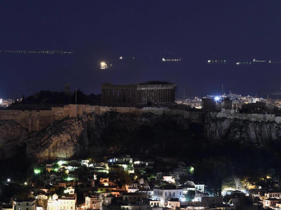 Ancient Temple of Parthenon atop Acropolis hill in the dark during Earth Hour (Getty Images)