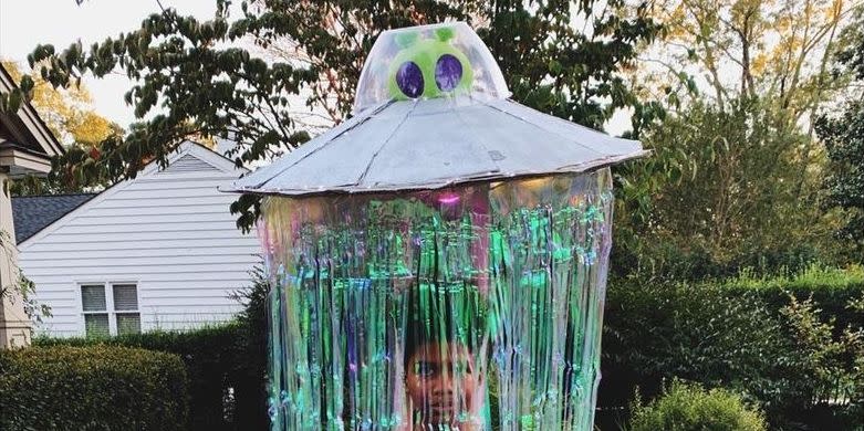 ufo halloween costume for tweens that looks like child is being beamed up by an alien spacecraft