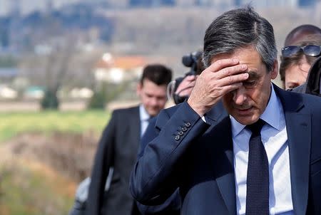 Francois Fillon, former French prime minister, member of the Republicans political party and 2017 presidential election candidate of the French centre-right holds his head as he walks in vineyards before a meeting with winegrowers in Nimes, France, March 2, 2017. REUTERS/Jean-Paul Pelissier