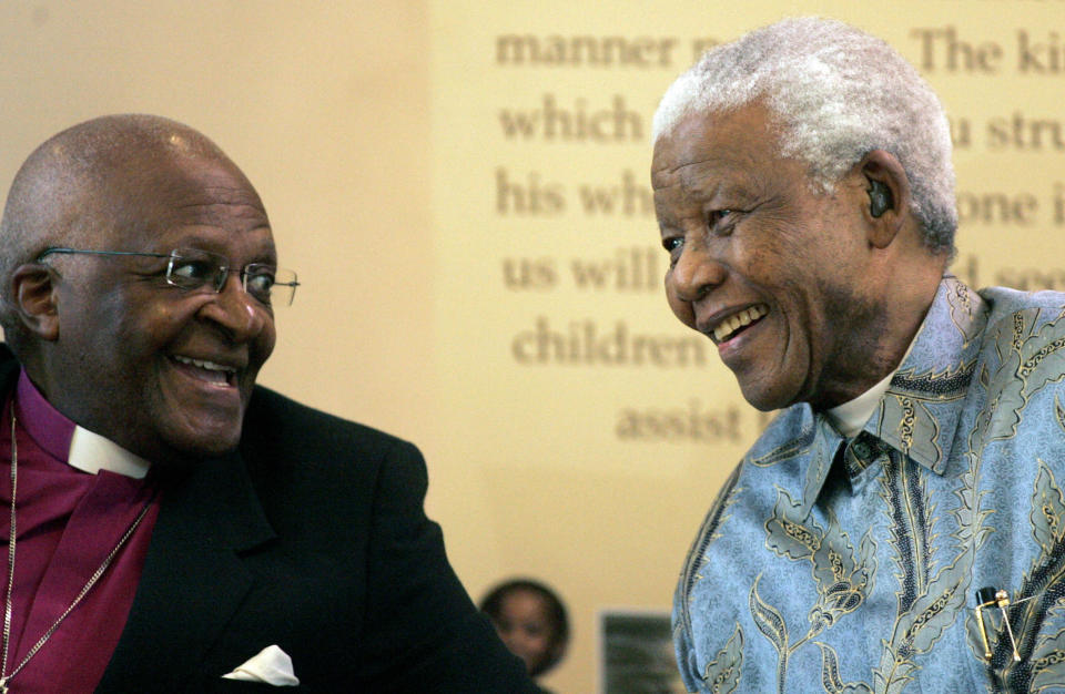 FILE - Former South African President Nelson Mandela, right, reacts with Archbishop Desmond Tutu during the launch of a Walter and Albertina Sisulu exhibition, called, 'Parenting a Nation', at the Nelson Mandela Foundation in Johannesburg, South Africa, Wednesday, March 12, 2008. When Tutu died Sunday, Dec. 26, 2021 at age 90, he was remembered as a Nobel laureate, a spiritual compass, a champion of the anti-apartheid struggle who turned to other global causes after Nelson Mandela, another moral heavyweight, became South Africa's first Black president. (AP Photo/Themba Hadebe, File)