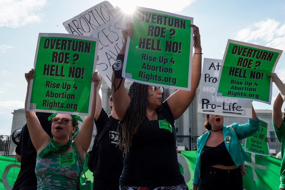 Anti-abortion and pro-abortion rights demonstrators protest in front of the Supreme Court in June.