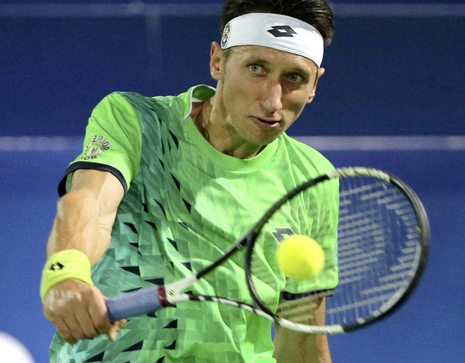 FILE -Sergiy Stakhovsky from Ukraine returns the ball to Stan Wawrinka from Switzerland during a second day match of the Dubai Tennis Championships in Dubai, United Arab Emirates, Tuesday, Feb. 23, 2016. About 1 1/2 months after the last match of Sergiy Stakhovsky’s professional tennis career, the 36-year-old Ukrainian left his wife and three young children in Hungary and went back to his birthplace to help however he could during Russia’s invasion. (AP Photo/Kamran Jebreili, File)