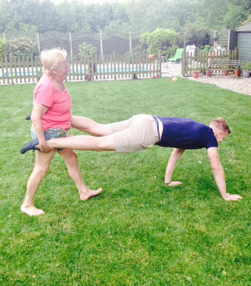 Leigh training in the garden with her grandson. (Caters)